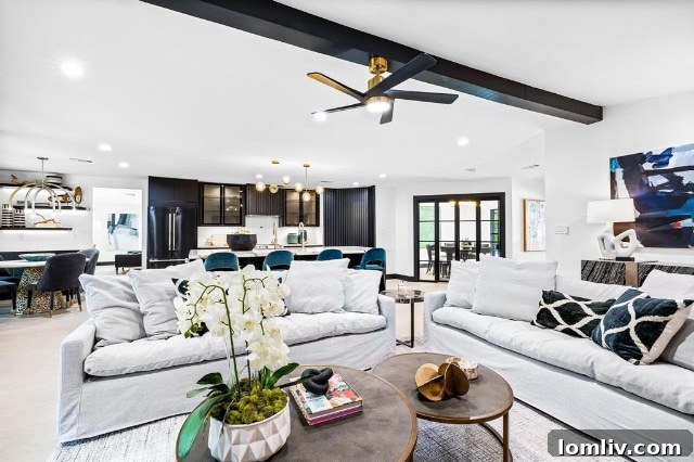A wide view of a bright and airy living space, showcasing the sophisticated design and comfortable atmosphere of the renovated 7336 Lakehurst.