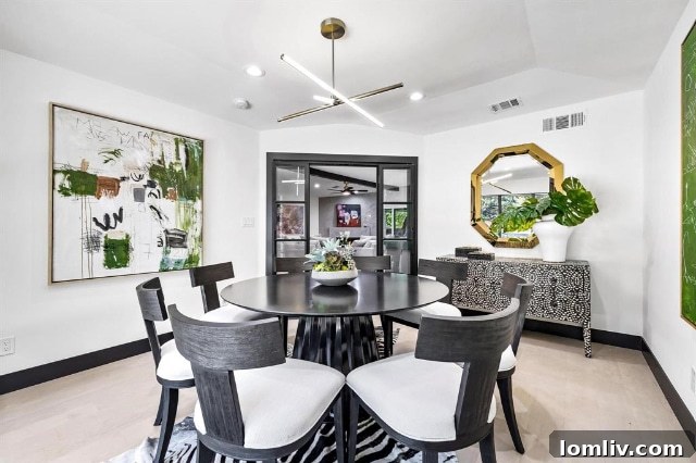 The elegant dining area of 7336 Lakehurst, staged to perfection by J. Guidry Design, emphasizing the home's luxurious and inviting atmosphere.