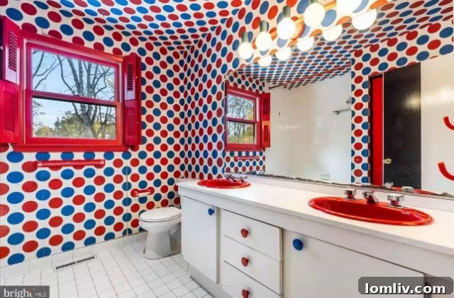 Bright white bathroom with a distinctive, slightly unsettling shower curtain