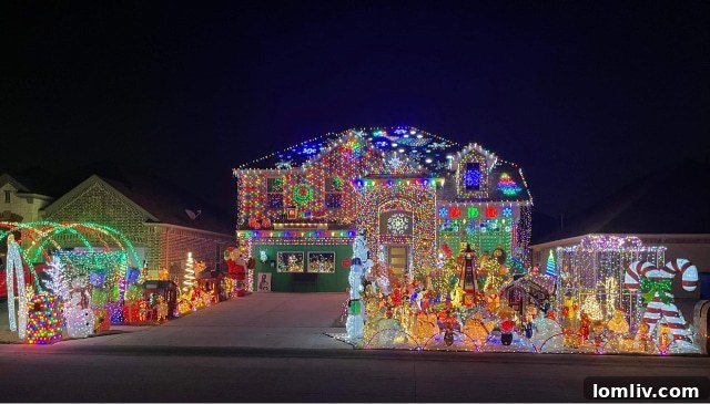 A wider shot showcasing a section of the Burkman family's elaborate Christmas display, featuring multiple illuminated elements and a glowing atmosphere.