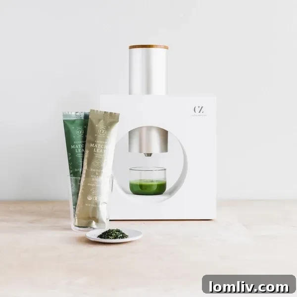 The Ultimate Holiday Gift Guide 12 A sleek and modern Cuzen Matcha Matcha Maker, prepared to whisk fresh matcha tea, appealing to tea lovers.