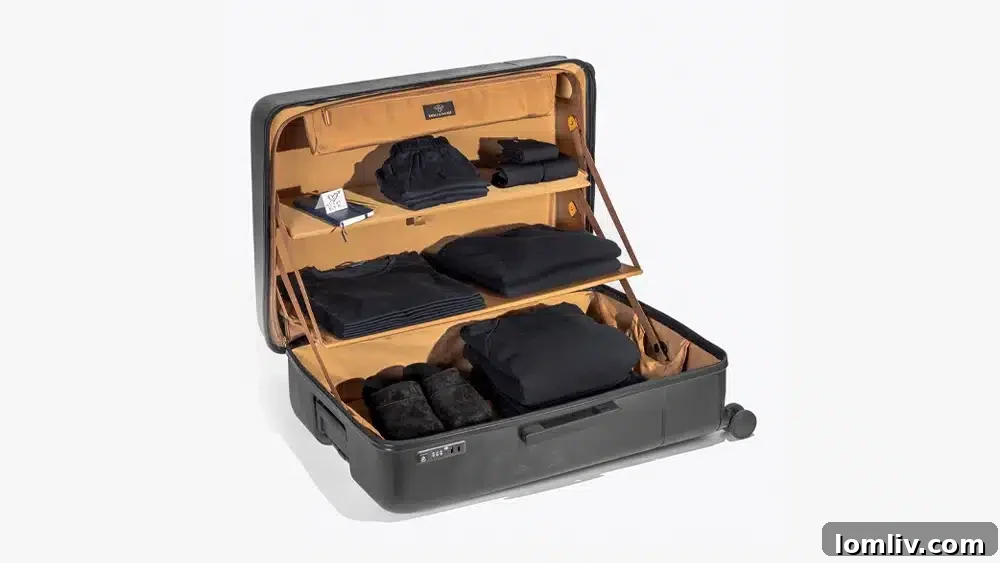 The Ultimate Holiday Gift Guide 9 A sleek Royce & Rocket Castle Classic suitcase, open to reveal innovative built-in shelving for organized packing.