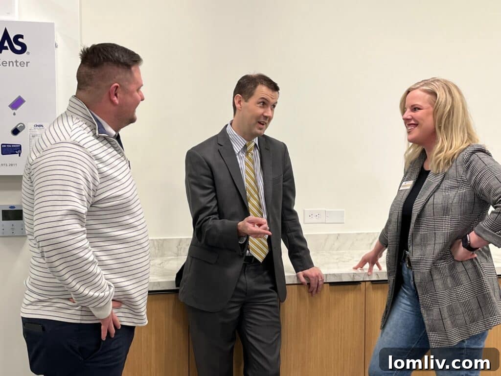 Cody Vaden, Matthew Church, and Ashley Gentry engaging in lively conversation at MetroTex Grand Opening