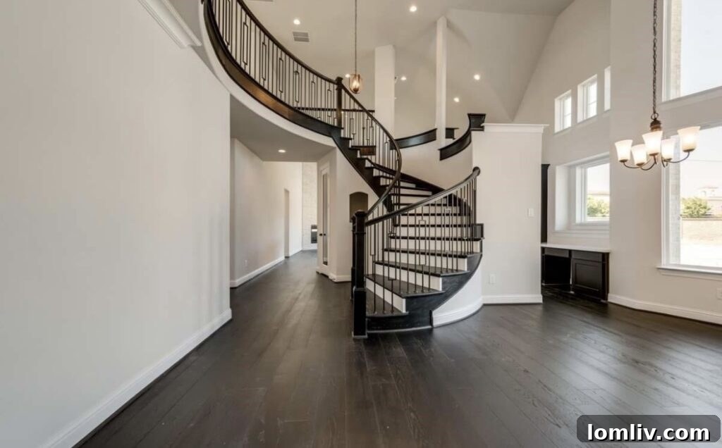 Grand entrance with oak staircase and wrought-iron spindles in Plano