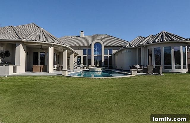Rear View of Home with Expansive Pool Deck and Greenbelt Access