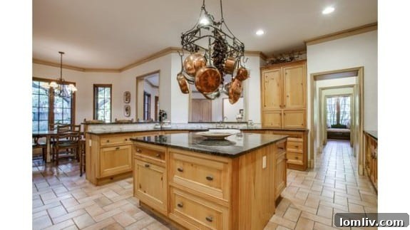 Gourmet kitchen with granite and butcher block counters, custom Christopher Peacock cabinetry, and commercial-grade appliances