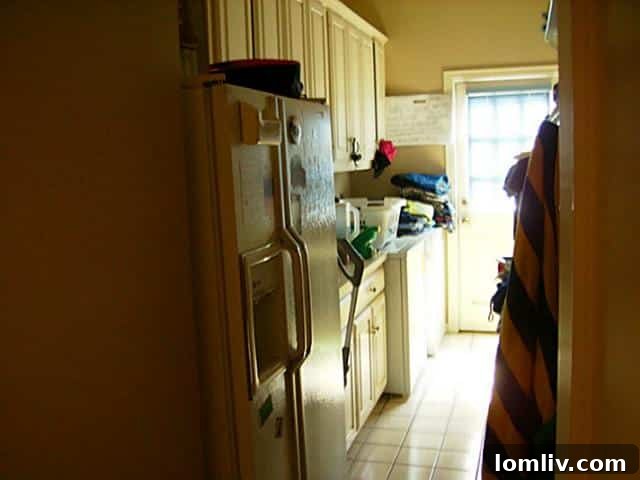 Laundry room at 5219 Scarborough Lane with a mop and other clutter, impacting visual appeal