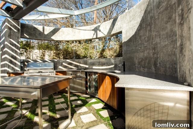 Sophisticated outdoor kitchen and dining area with a steel-and-wood cantilevered canopy