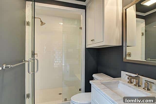 Modern master bathroom with subway tile shower and frameless glass