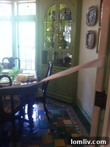 Green cabinetry contrasted with blue and white china