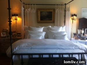 Master bedroom with fluffy bed and white linens