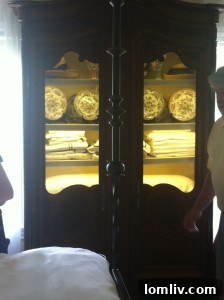 Glass door armoire displaying fresh linens