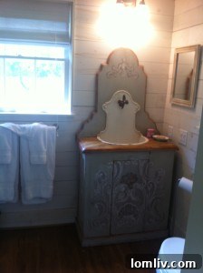 Carriage house bathroom with farmhouse walls and antique sink