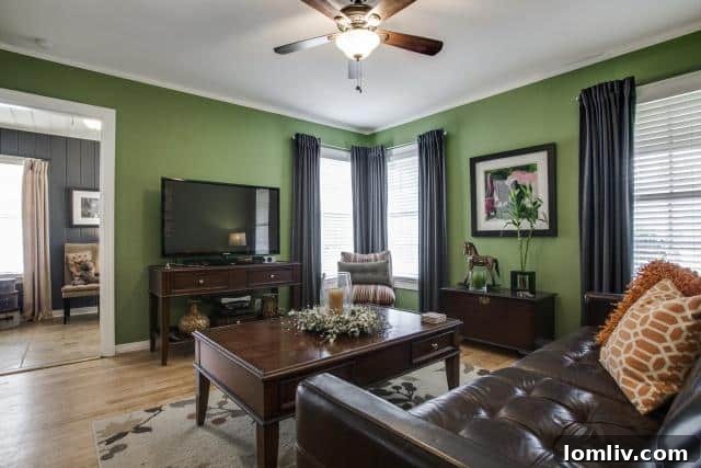 Second bedroom or living area at 2531 W 10th Street featuring Kelly green walls, modern furniture, and a cat tree