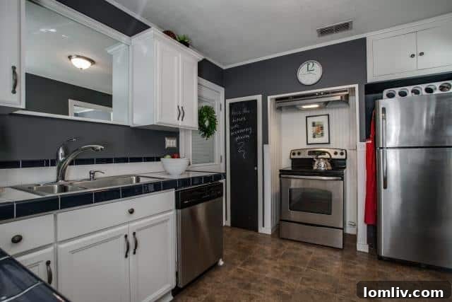 Close-up of the kitchen at 2531 W 10th Street showing a quirky mirror above the sink and a chalkboard pantry door