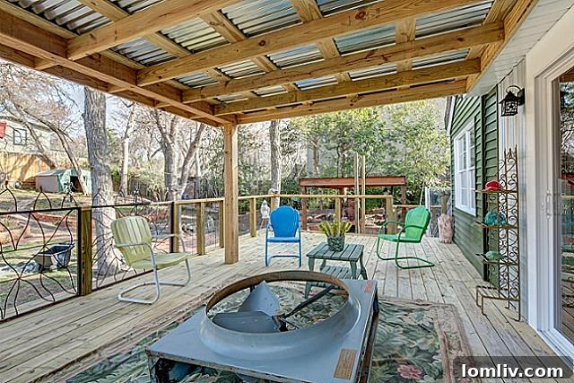 Multi-level deck overlooking the expansive, treed backyard of 9003 Groveland