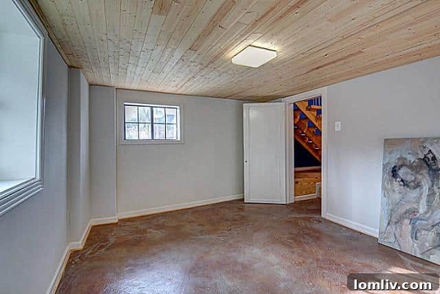 Cozy master bedroom with ample natural light in the unique 9003 Groveland residence