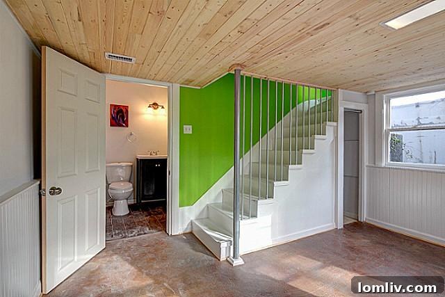 Elegant powder room and staircase area at 9003 Groveland, highlighting modern finishes