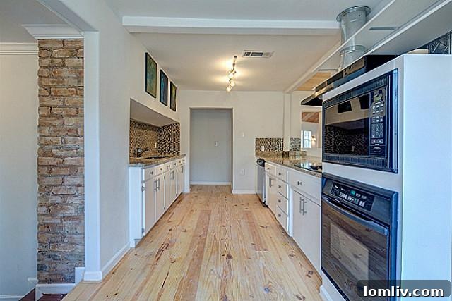 Beautifully renovated kitchen with granite countertops and new appliances at 9003 Groveland