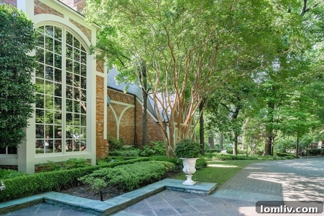 Lush gardens and mature trees surrounding the estate at 9250 Meadowbrook Drive