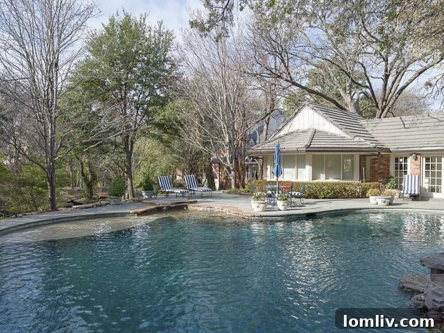 Resort-style pool with waterfall, offering a refreshing escape at 9250 Meadowbrook
