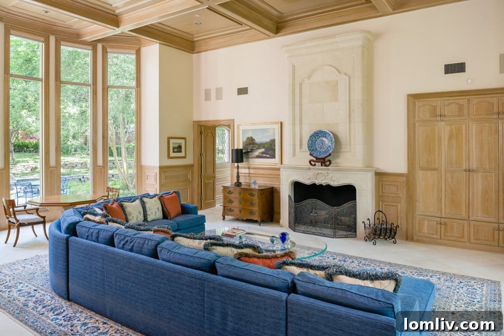 Comfortable family room with stone fireplace, connecting to the gourmet kitchen at 9250 Meadowbrook