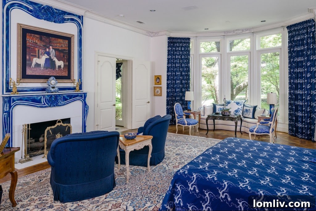 Luxurious master bedroom with sitting area and scenic views at 9250 Meadowbrook Drive