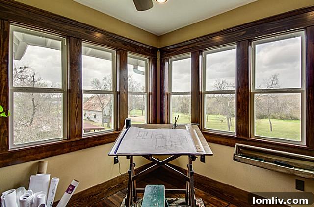 Cozy and well-lit study located within the master suite of 2113 Mangum, offering a private space with large corner windows providing beautiful views and natural light.