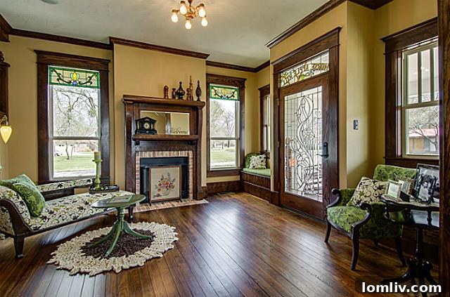 View of the elegant parlor inside 2113 Mangum, featuring classic period furniture, intricate wood detailing, a grand fireplace, and a warm, inviting atmosphere for formal gatherings.