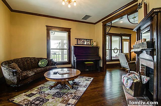 Another perspective of the charming parlor at 2113 Mangum, highlighting its spacious layout, original architectural elements, and inviting ambiance, perfect for receiving guests.