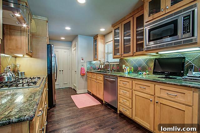 Modern kitchen with new cabinets, countertops, and custom fixtures at 6202 Monticello