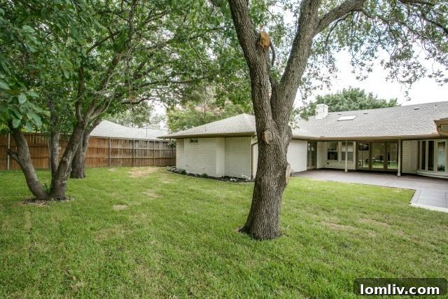 Large, fenced backyard with mature trees, perfect for pets and children
