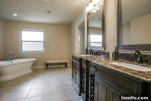 Elegant master bathroom with a freestanding soaking tub and dual vanity