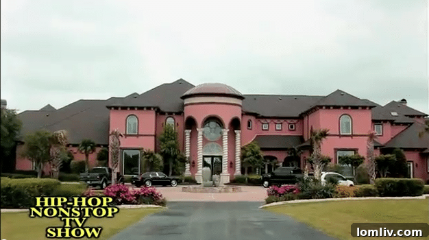 An archival image displaying a pink-hued luxury home, potentially referenced in discussions about Deion Sanders' historical property acquisitions.