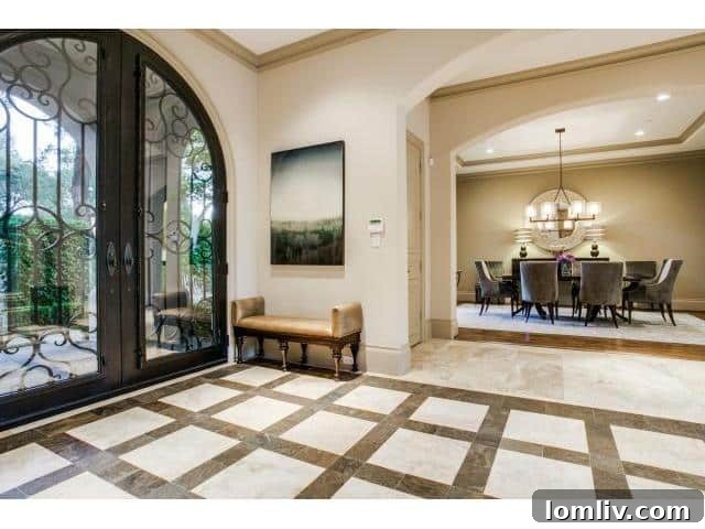 Grand foyer with high ceilings and elegant stone floors in a luxury Dallas home
