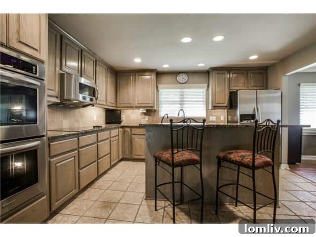 Gourmet Kitchen with Custom Cabinetry and Eat-In Island at 2848 Woodmere