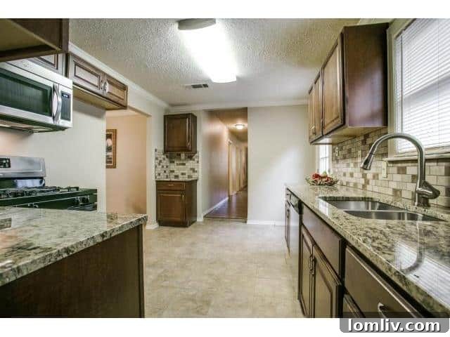 Another view of the kitchen, showcasing the basic cabinetry and the limited counter space.