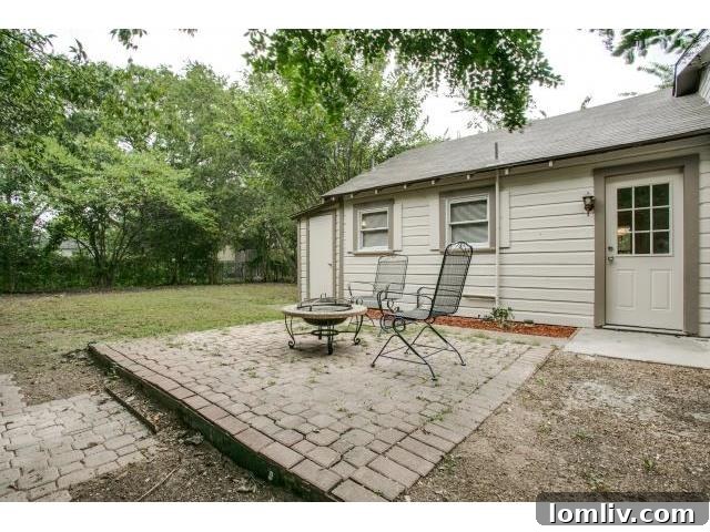 The backyard of 8927 Daytonia, featuring a brick patio surrounded by untended weeds, showing a clear opportunity for landscaping improvements.
