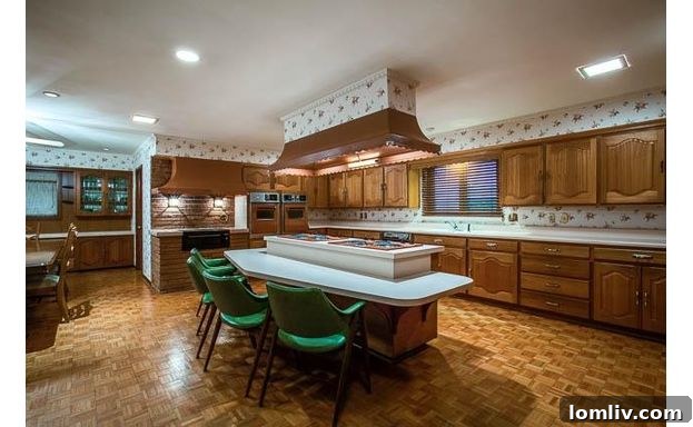 Westlake Kitchen - Before Renovation: Showing kitschy wallpaper and vintage fixtures