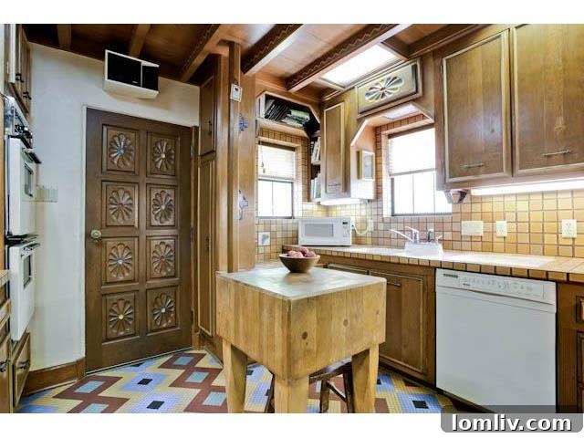 A view of the charming but compact kitchen at 3544 Rankin Street, featuring beautiful mosaic tile flooring.