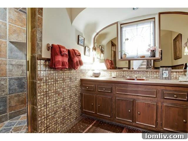 The stunning master bathroom, featuring exquisite tile work and a luxurious ambiance at 3544 Rankin Street.