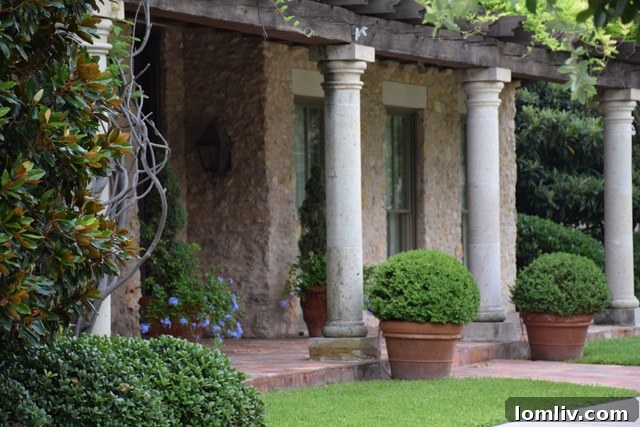 Ornate limestone plinths from Luders above windows and columns from Mexico with antique Spanish tiles on Jane McGarry's former home.