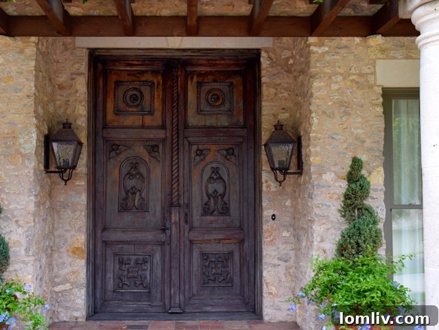 Close-up of the front doors of Jane McGarry's former home, showcasing rare 18th Century Peruvian wood carvings.