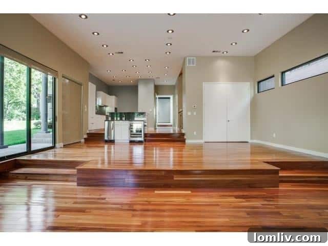 Spacious living room with vaulted ceilings, brick fireplace, and sliding glass doors
