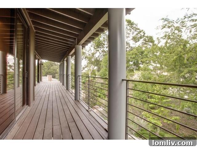 Long wooden balcony accessible from second-floor bedrooms, offering treetop views