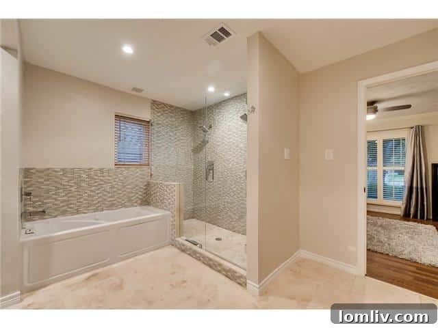 Sparkman Club: A Blend of Classic Elegance and Modern Luxury, Featuring a Magnificent Pool 12 Luxurious master bathroom with dual vanities separated by a privacy wall, offering ample space and convenience.