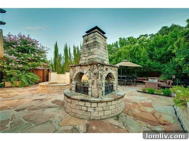 Elegant multi-sided fireplace in the backyard, perfect for cozy evenings and outdoor entertaining.