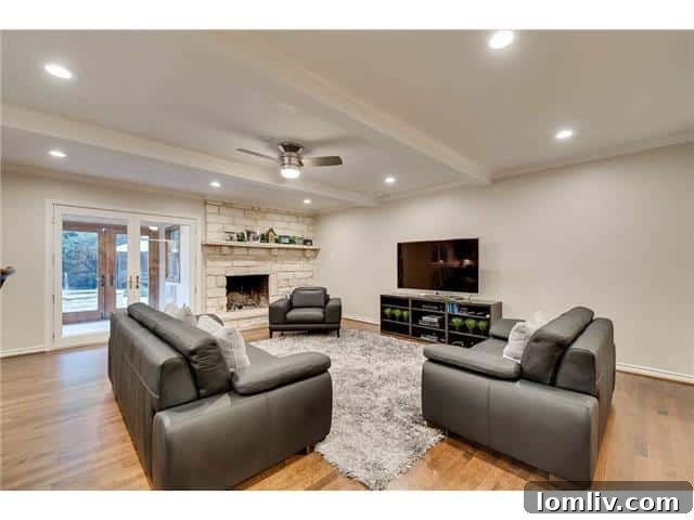 Sparkman Club: A Blend of Classic Elegance and Modern Luxury, Featuring a Magnificent Pool 6 Comfortable and stylish family room at 3242 Princess Lane, featuring a modern fireplace and elegant finishes.