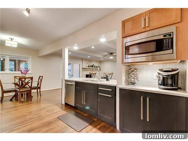 Sparkman Club: A Blend of Classic Elegance and Modern Luxury, Featuring a Magnificent Pool 9 Detailed view of the modern kitchen with two-tone cabinetry and high-end finishes, perfect for culinary enthusiasts.