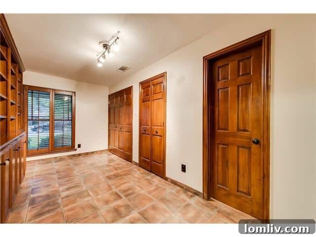 Sparkman Club: A Blend of Classic Elegance and Modern Luxury, Featuring a Magnificent Pool 10 Dedicated home office or library at 3242 Princess Lane, featuring charming Saltillo tile floors for a productive and peaceful environment.